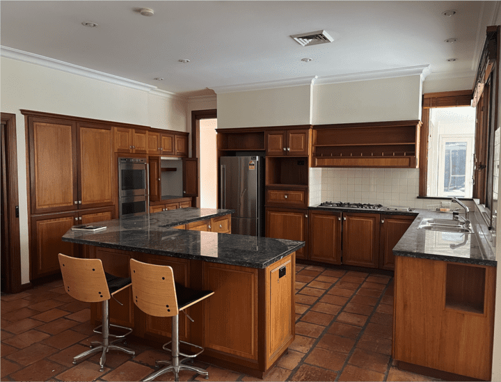 Traditional Kitchen with Dark Wood Cabinets and Black Granite Countertops