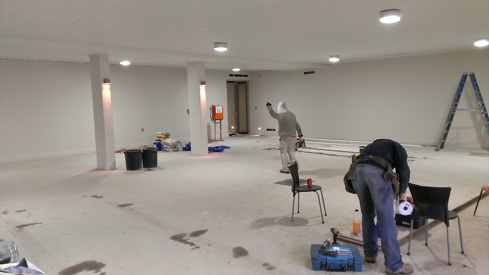 Interior painting service in Brighton – painters working on a large open-plan space