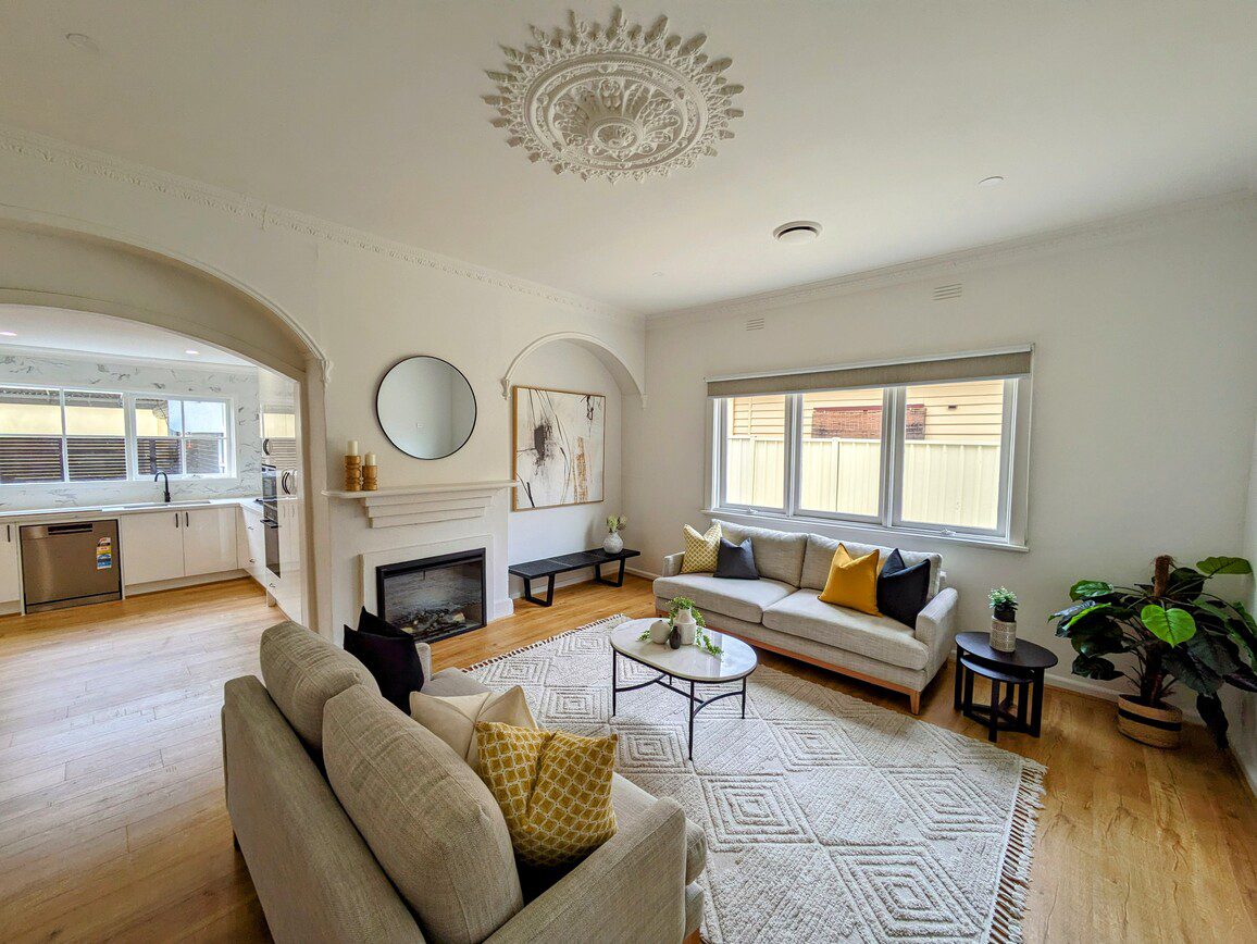 Spacious Living Room with Elegant Fireplace and Modern Kitchen in the Background